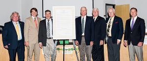 Board members pictured next to a proclamation