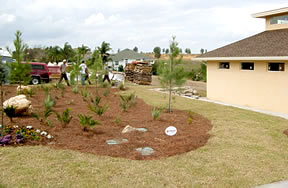 Workers put the finishing touches on the landscape