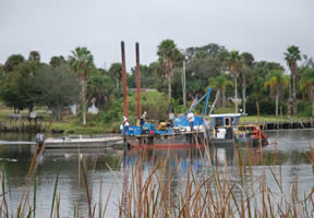 A dredging crew removes silt