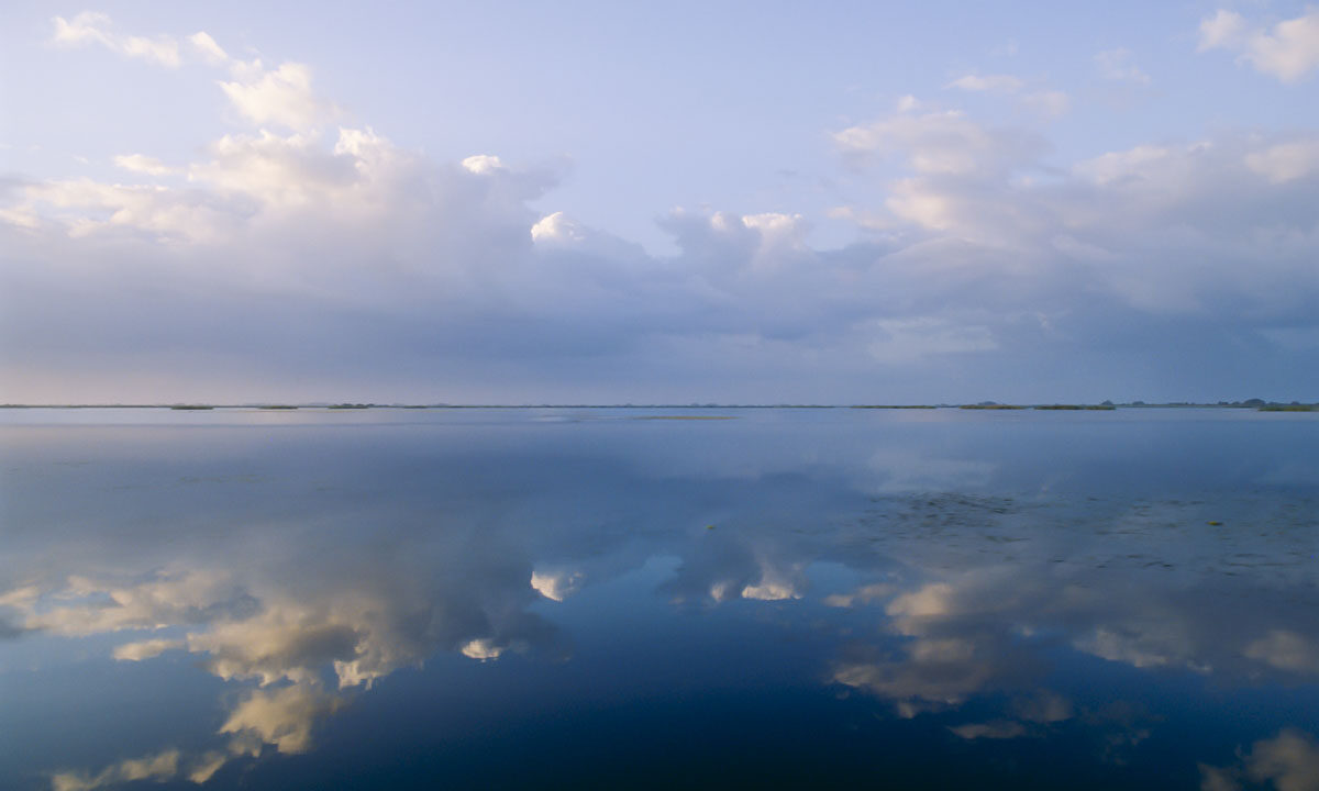 Clouds reflecting in open water at Blue Cypress Conservation Area