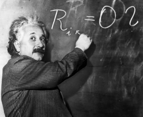 Einstein Albert Einstein writing on a chalk board