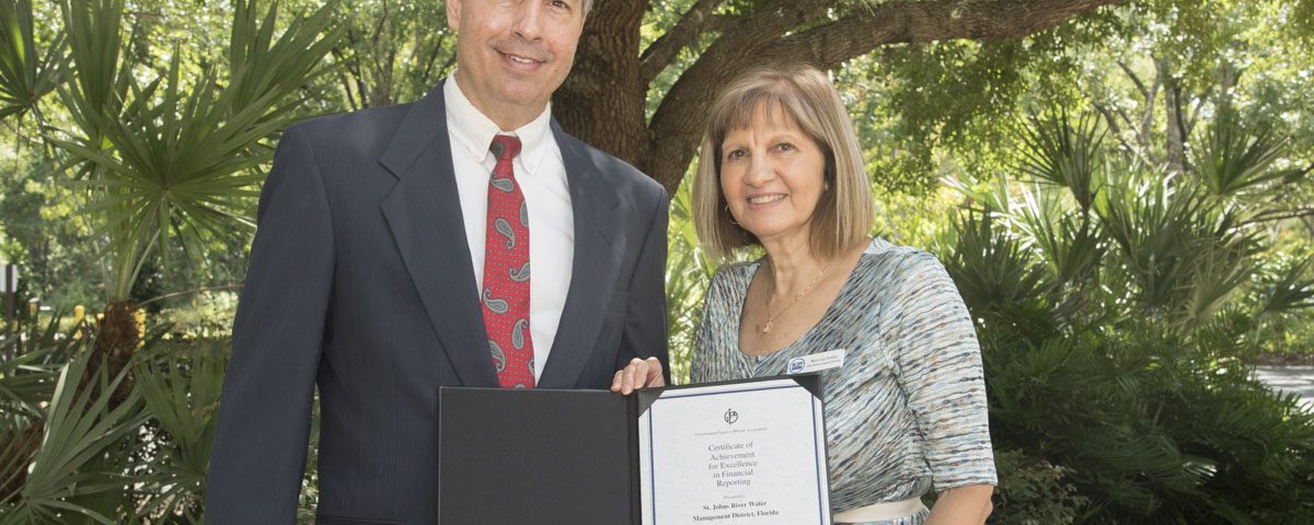 Mary-Lou Pickles and Greg Rockwell with a finance award