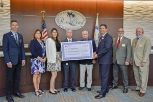 Jim Troiano and the City of Palm Coast Commissioners with a cost-share check