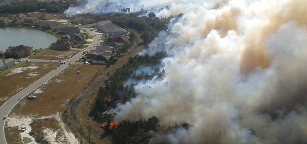 Aerial of a prescribed fire burning next to a neighborhood