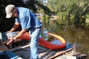 District staff connecting up a pump to alleviate flooding