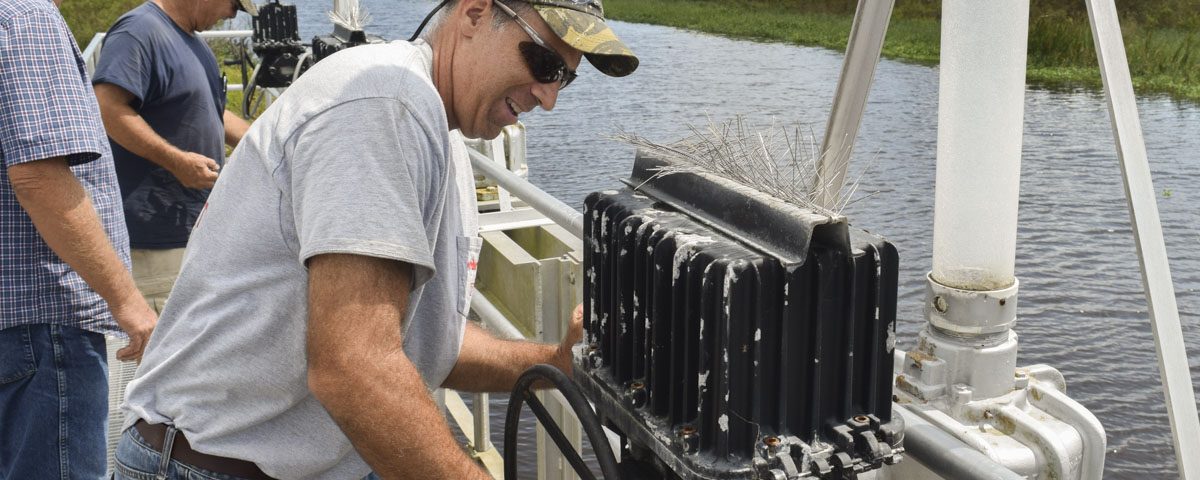 District staff opening gates on water control structure