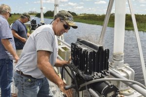 District staff opening gates on water control structure