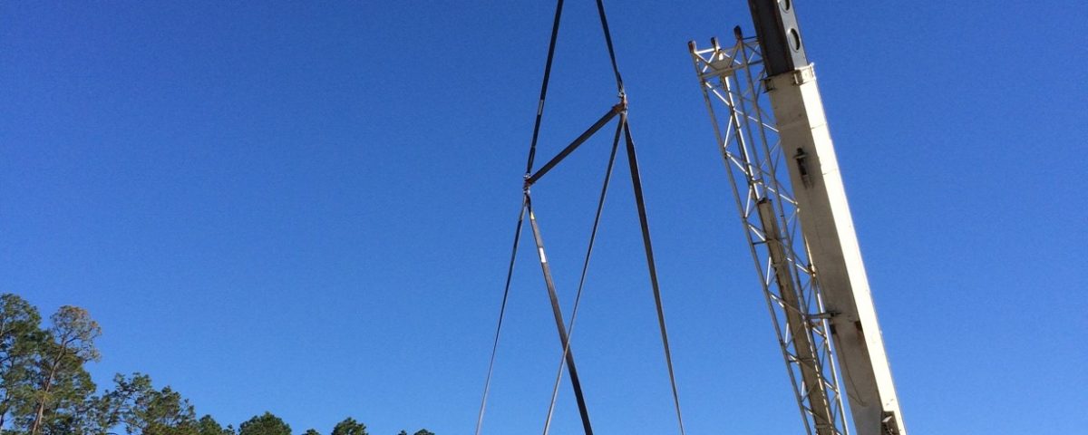 Crane lifting a large generator during installation at Palatka wastewater treatment plant