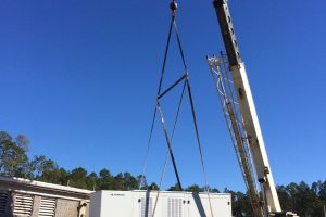Crane lifting a large generator during installation at Palatka wastewater treatment plant