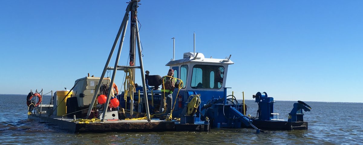 Perople working on a dredging barge on Lake Apopka