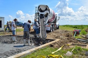 Construction crew pouring a concrete pad