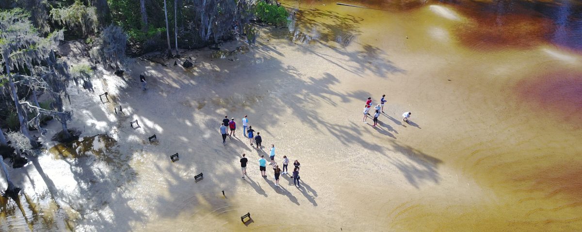 Aerial of students on the shore of the St. Johns River near Jacksonville