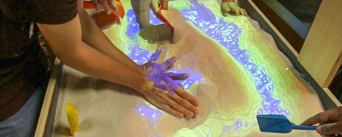 Students interacting with a science exhibit