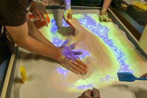 Students interacting with a science exhibit