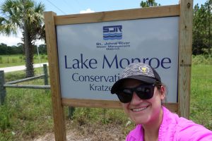 Selfie of a woman in front of the Lake Monroes Conservation Area entrance sign