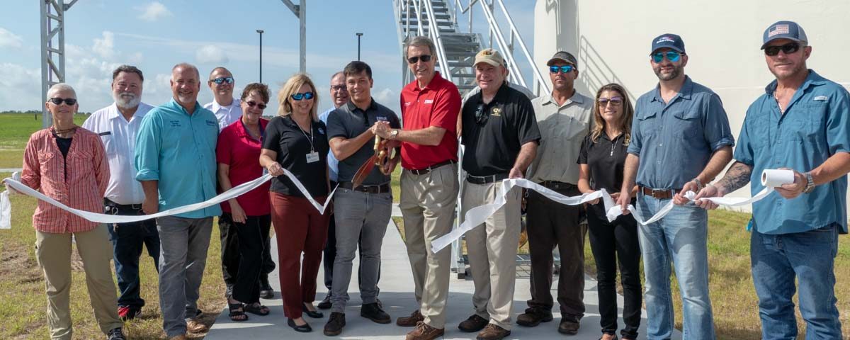Lisa Kelley and shreholders cutting the ribbon at the Eustis Wastewater Treatment Plant Ribbon Cutting Event