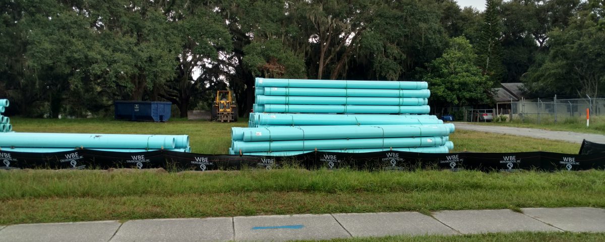 Stacks of large water pipes in a field