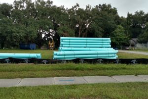 Stacks of large water pipes in a field