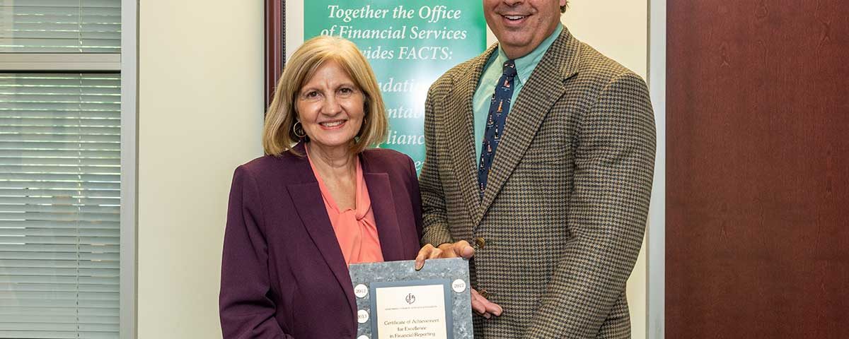 Mary-Lou Pickles and Greg Rockwell with a finance award