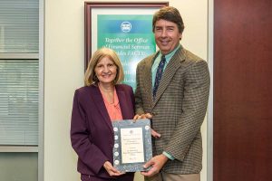 Mary-Lou Pickles and Greg Rockwell with a finance award