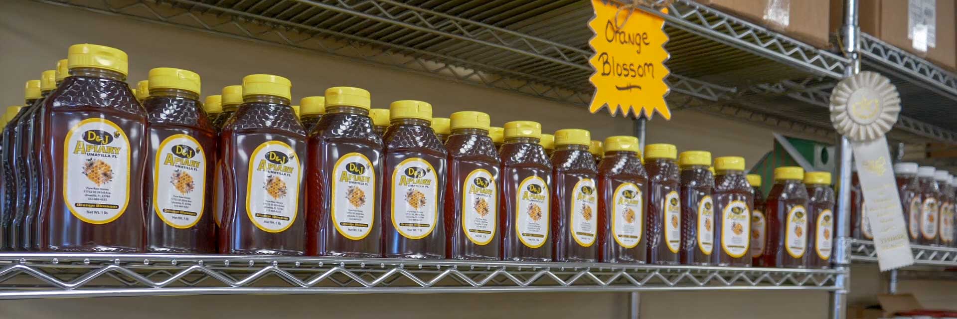Bottles of honey sitting on a shelf