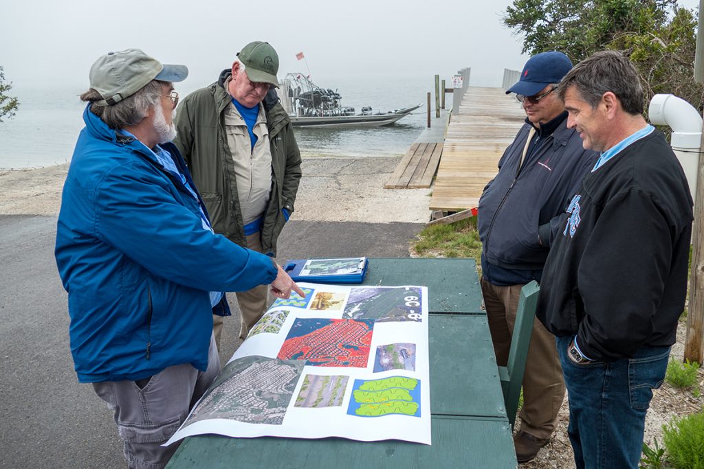 Ron Brockmeyer discussing a project with shareholders District staff discussing restoration project with shareholders at a boat ramp