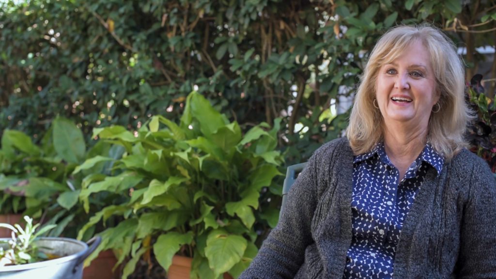 Deborah Weaver sitting in her garden