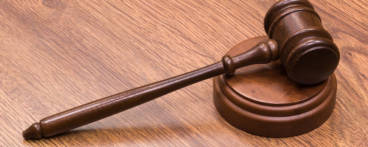 A gavel resting on a sounding block