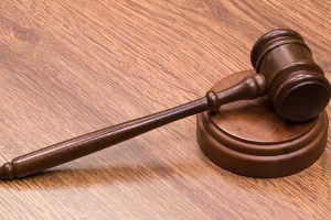 A gavel resting on a sounding block