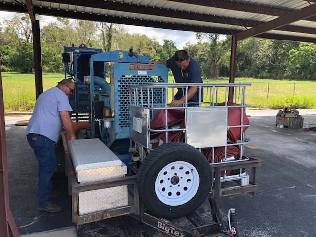 District staff working on pumping equipment