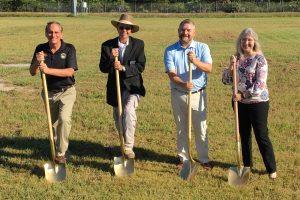 State representatives holding golden shovels
