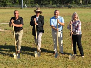 State representatives holding golden shovels