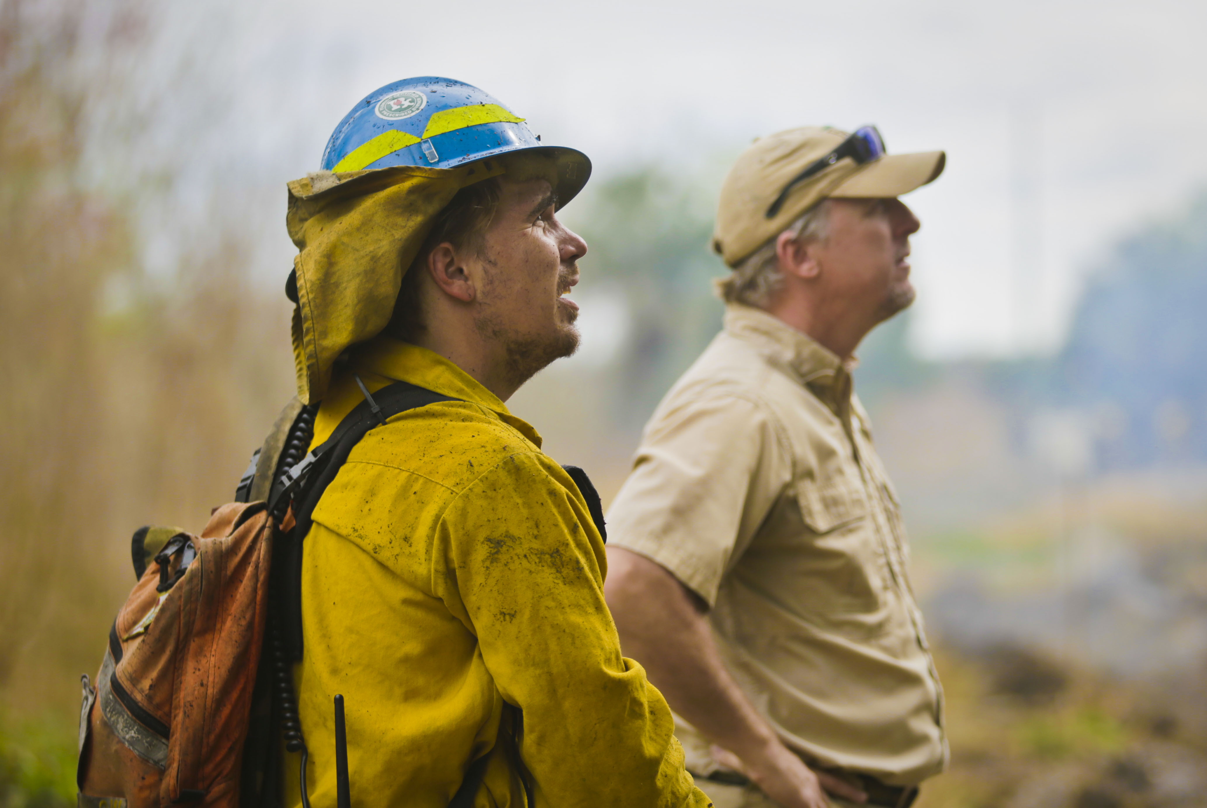Land Manager Chris Kinslow (left) monitors conditions of a prescribed fire
