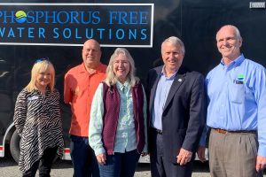 Five people standing infront of a trailer with a Phosphorus Free Water Solutions sign
