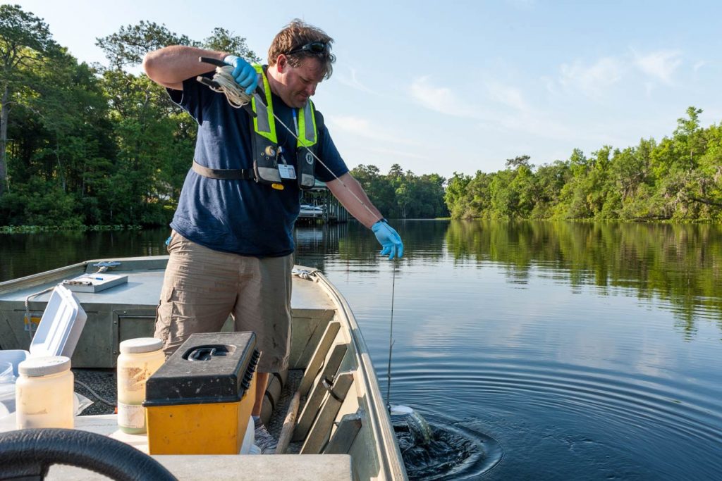 A District scientist uses a Secchi disk to determine water quality