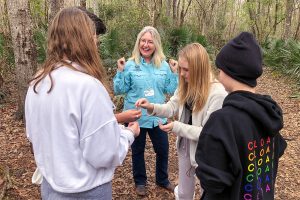 Dr. Ann Shortelle with students in the woods