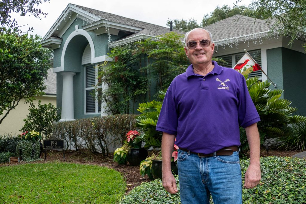 Art Gallo standing by his home