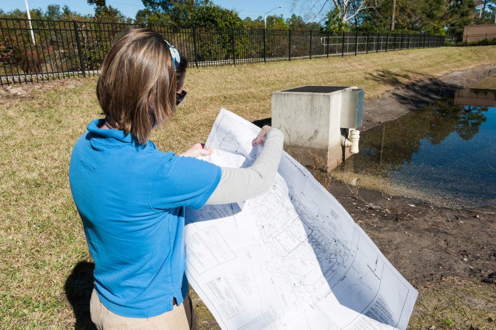District regulatory staff holding blueprints
