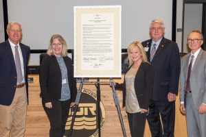 District board members standing by sign