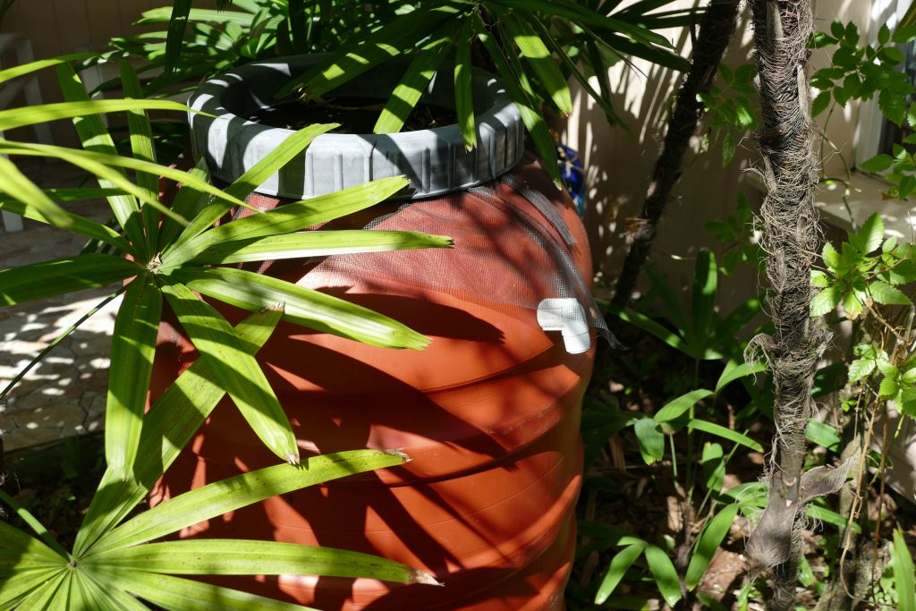 Abbey-Calhoun-1 An orange rain barrel tucked away in brush