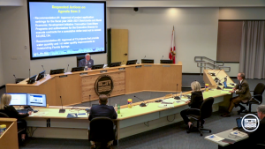 Douglas Burnett leading a Governing Board meeting