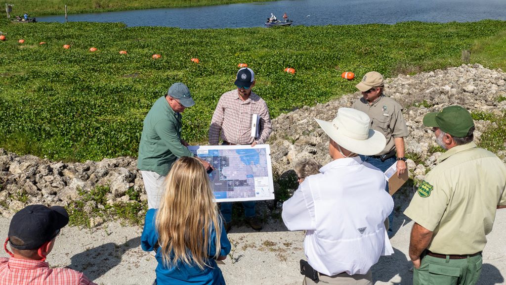 Members of the Land Management Review Team studying maps