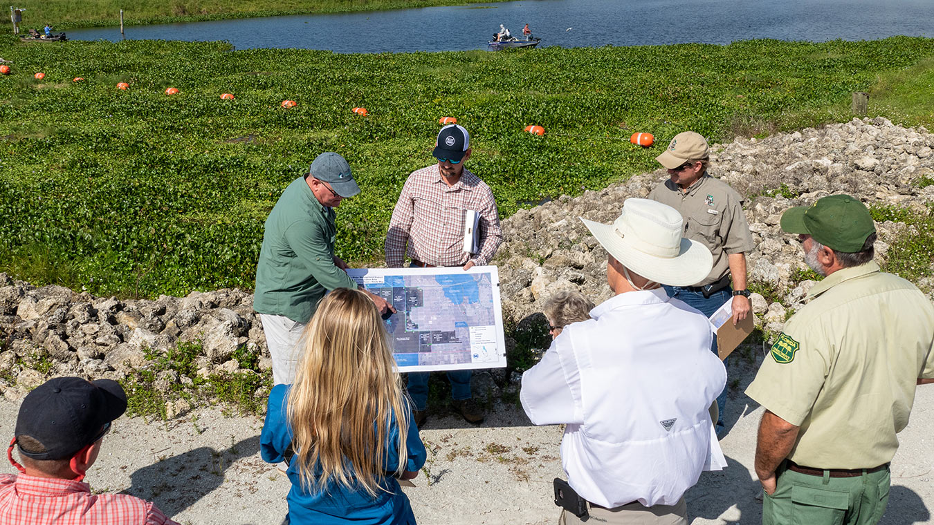 Members of the Land Management Review Team studying maps