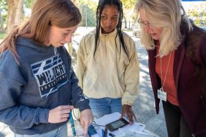 Dr. Ann Shortelle showing students water-quality technology