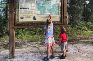 Boy and girl looking at a trail map