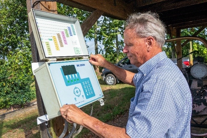 Citrus grower Cody Estes monitors a weather station at his grove
