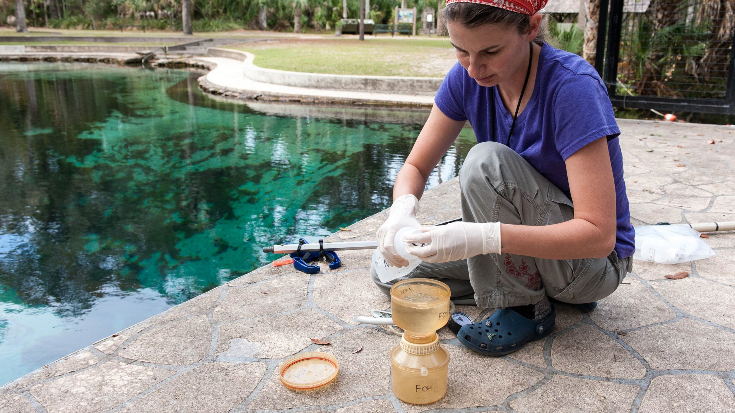 Tiffany Trent testing water next to a pool
