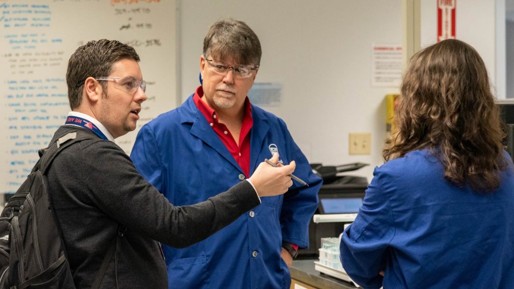 science teacher Euan Hunter talking with two students
