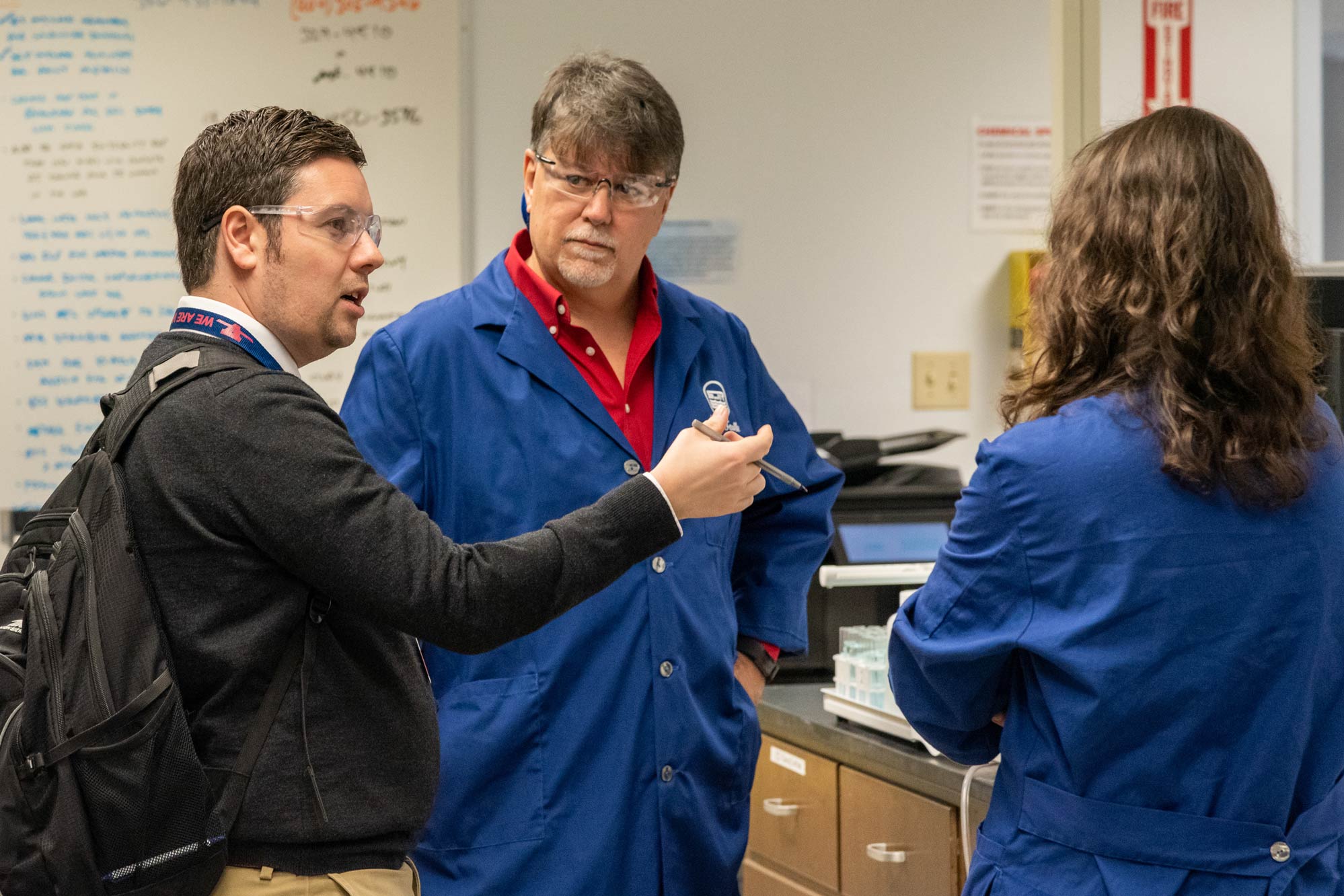 science teacher Euan Hunter talking with two students