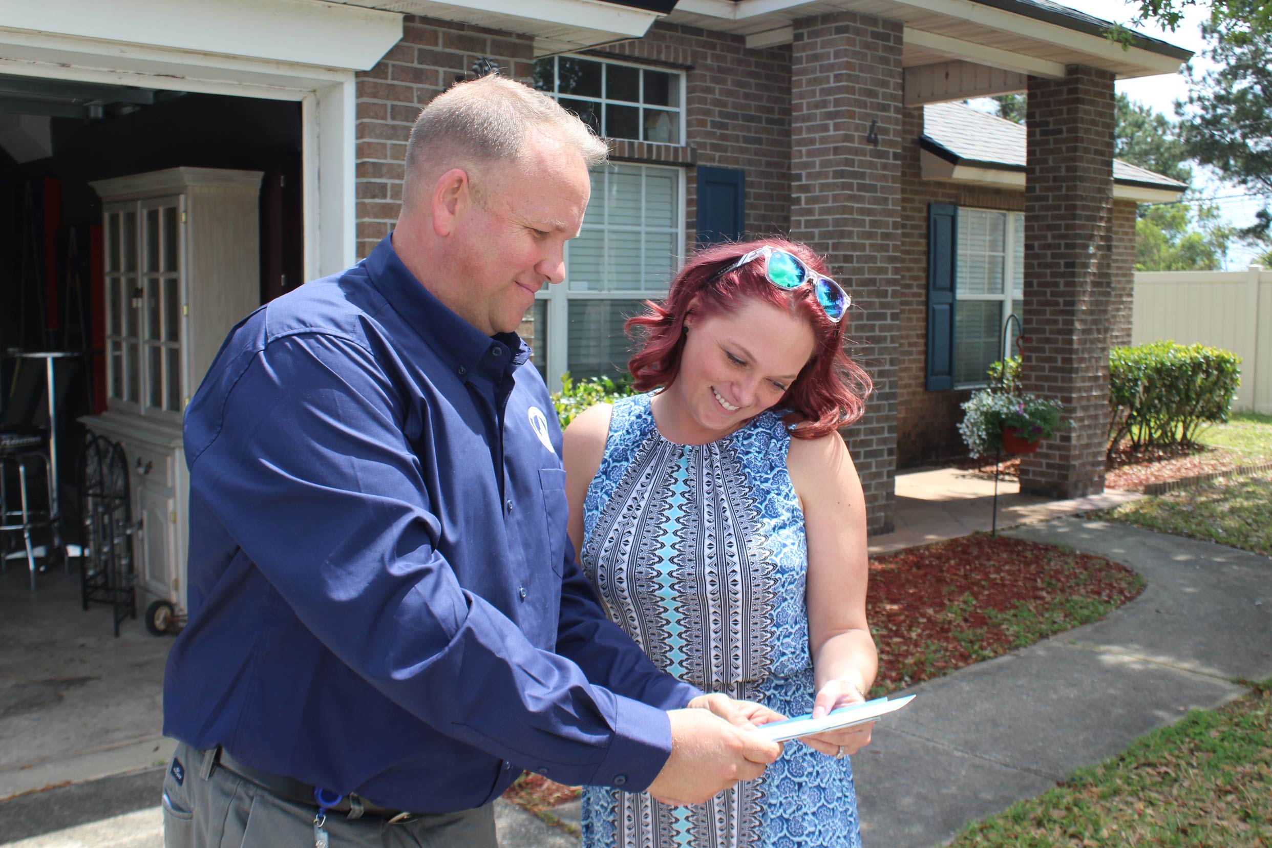 Matt McMullin, who leads Clay County Utility Authority’s leak detection program, meets with a homeowner to review a leak assessment of her property.